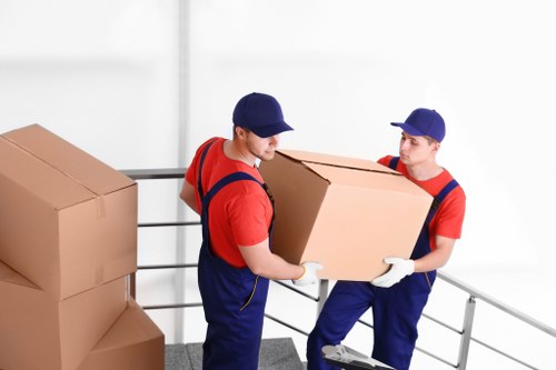 Helper carrying boxes for a small move in Brixton