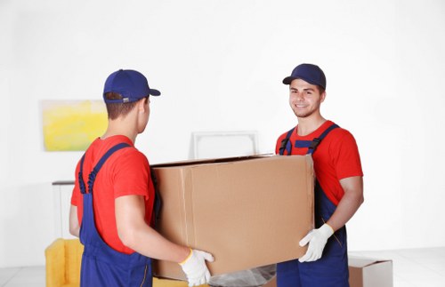 Packed moving boxes and furniture ready for transport in a Brixton removals van