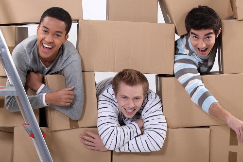 Moving boxes and furniture being loaded for a Brixton house or flat move