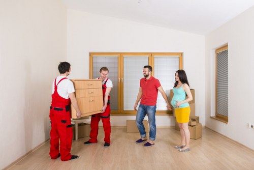 Furniture and boxes being loaded into a moving van in Brixton