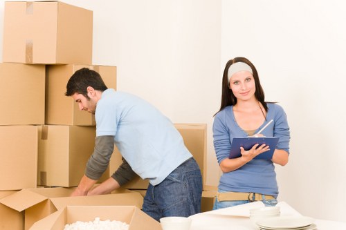 Packed moving boxes and furniture ready for transport in Brixton